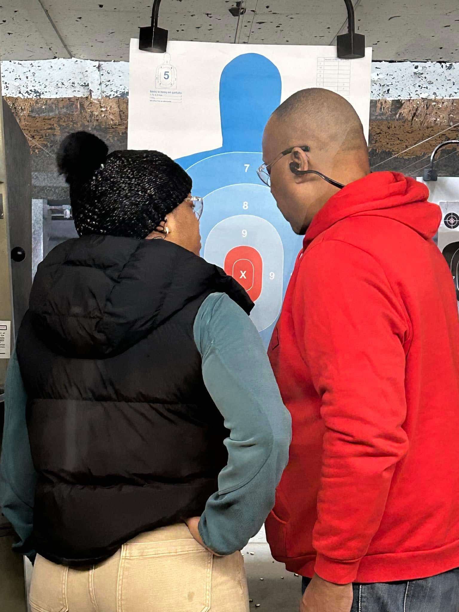 Students reviewing target placement during firearm safety training